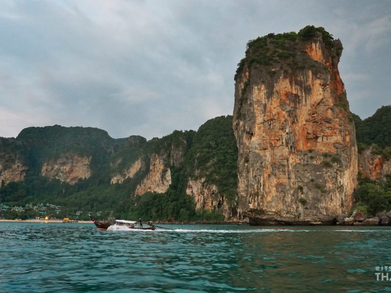 Tonsai Bay in Thailand with longtail boat driving past
