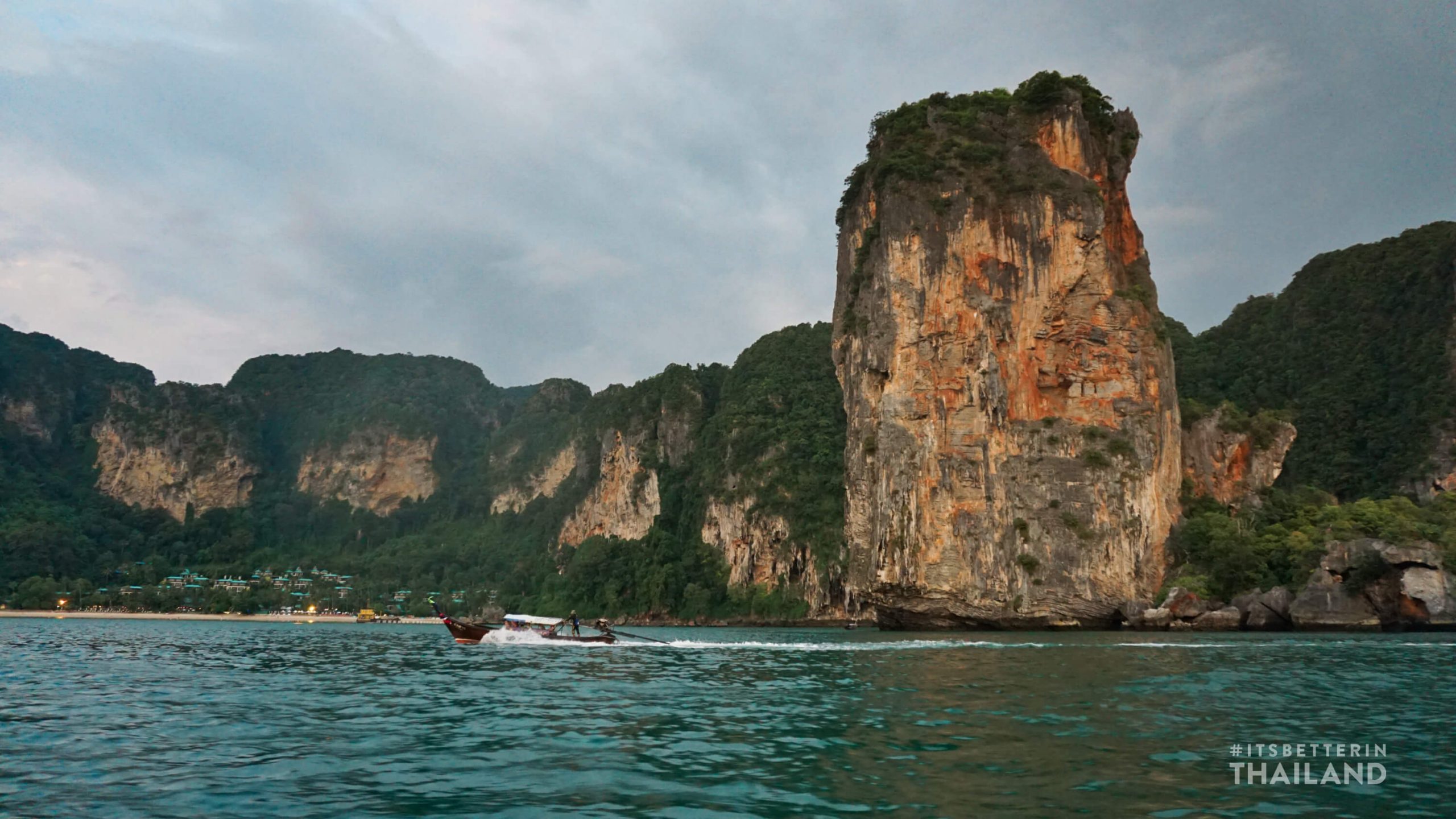 Tonsai Bay in Thailand with longtail boat driving past